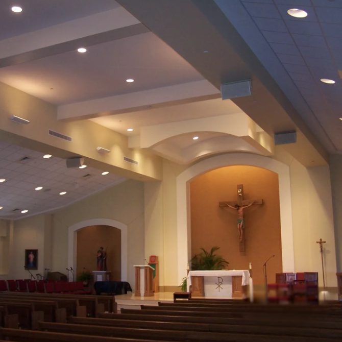 A church with a cross on the wall and pews